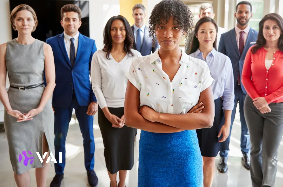 Confident team of diverse employees standing together in a modern office